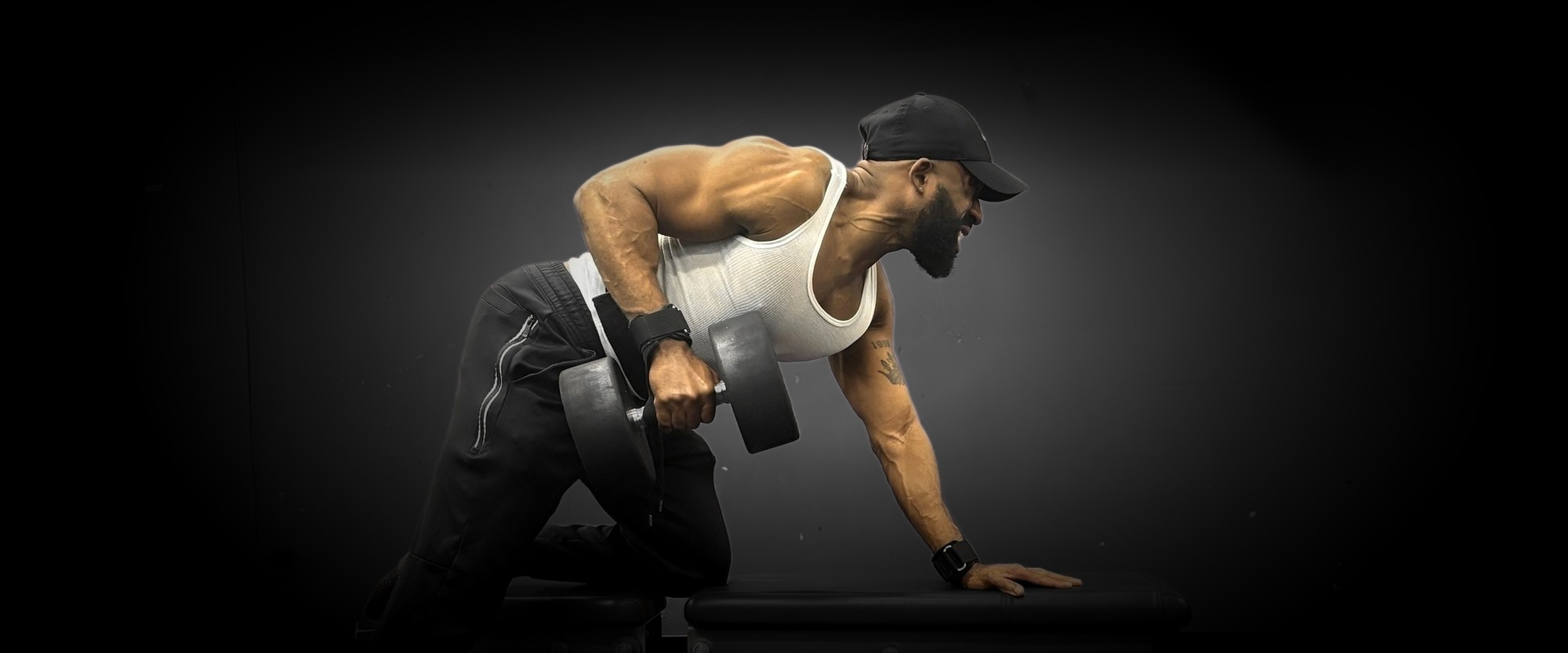 Coach Rashad doing a one-arm dumbbell row